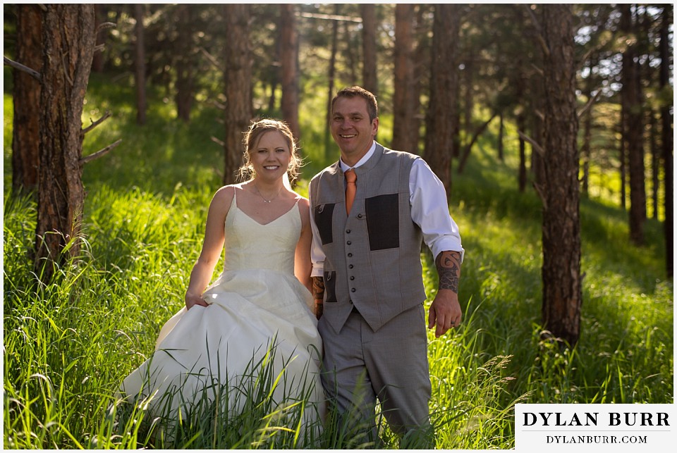 flagstaff house wedding boulder colorado wedding reception party bride and groom walking in tall grass