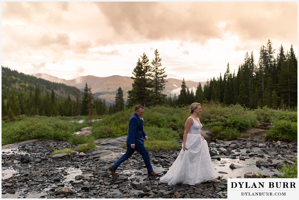 breckenridge blue lakes elopement wedding colorado couple walking across creek