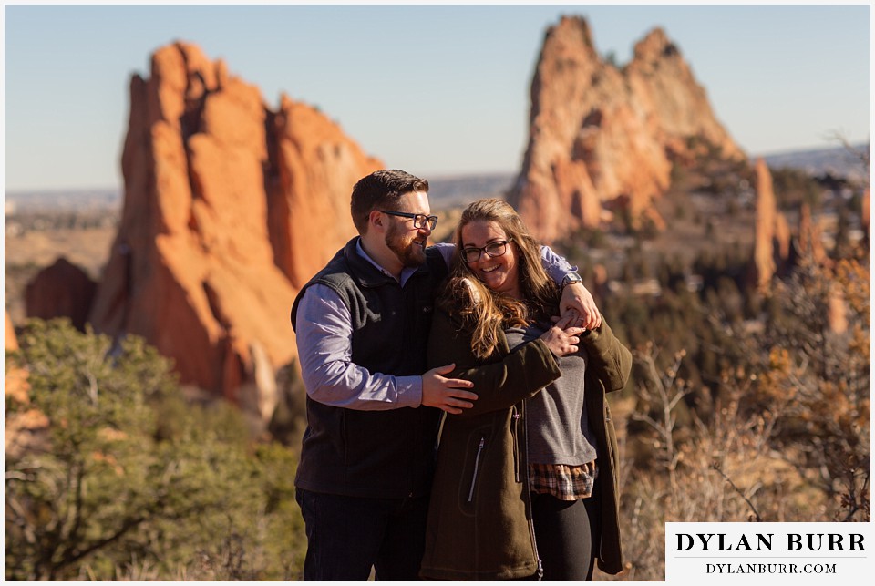 garden of the gods engagement session couple holding eachother and laughing