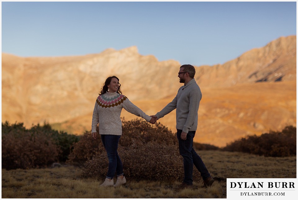 georgetown colorado engagement session couple walking with mountains in background