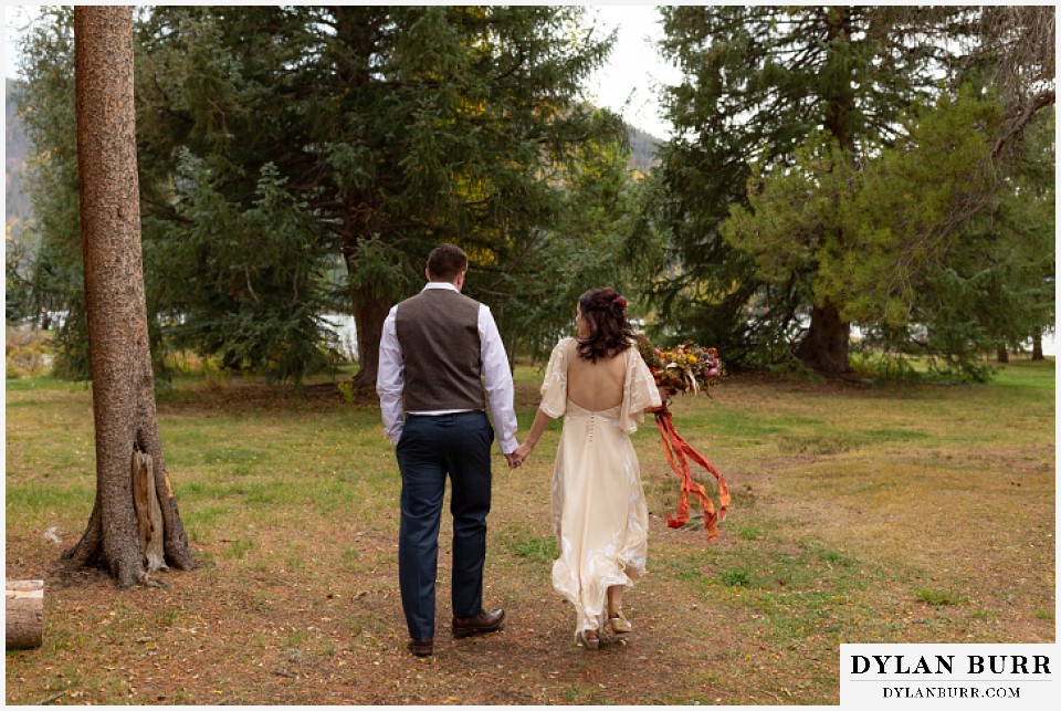 grand lake wedding elopement bride and groom walking towards lake