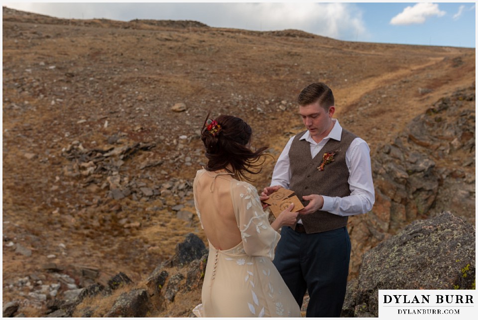 rocky mountain national park grand lake wedding elopement bride and groom exchanging vow booklets