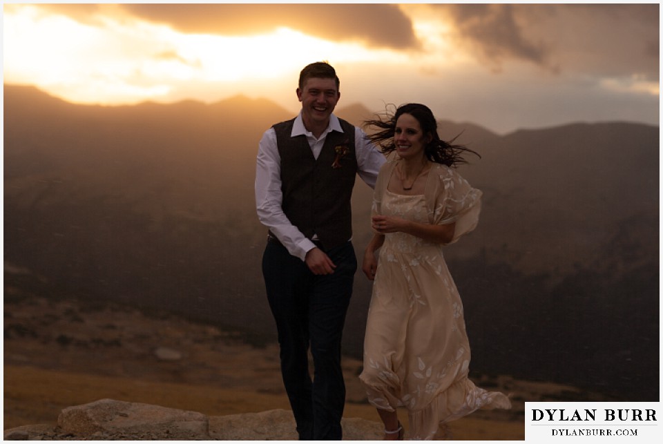 rocky mountain national park grand lake wedding elopement bride and groom running in cold wind