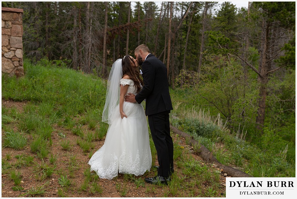 camp st malo wedding allenspark colorado estes park mountain wedding bride and groom first look kiss