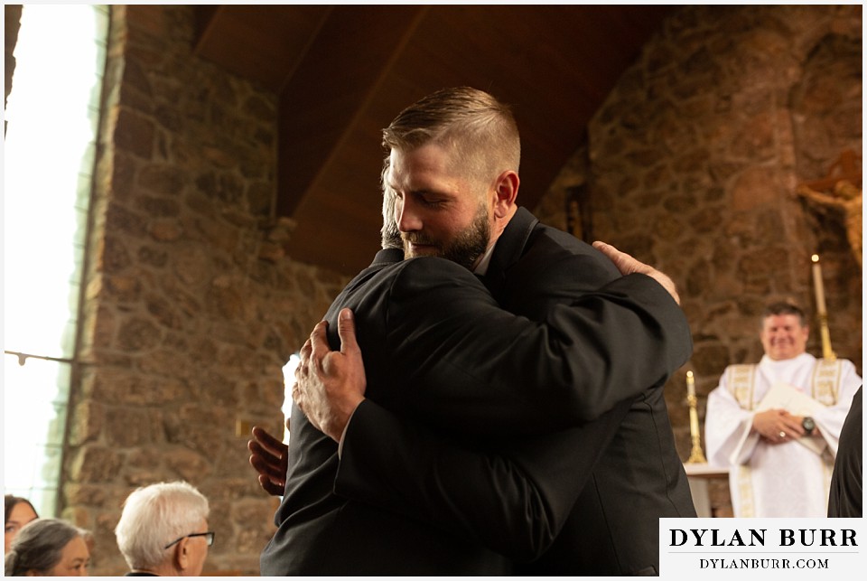 camp st malo wedding allenspark colorado estes park mountain wedding groom hugging father