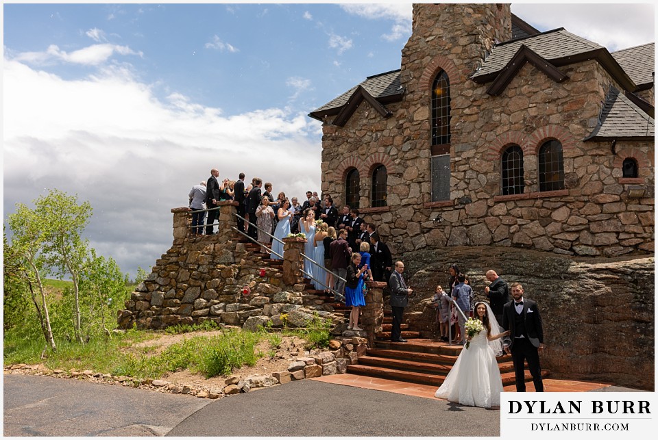 camp st malo wedding allenspark colorado estes park mountain wedding bride and groom leaving church with bubbles in air