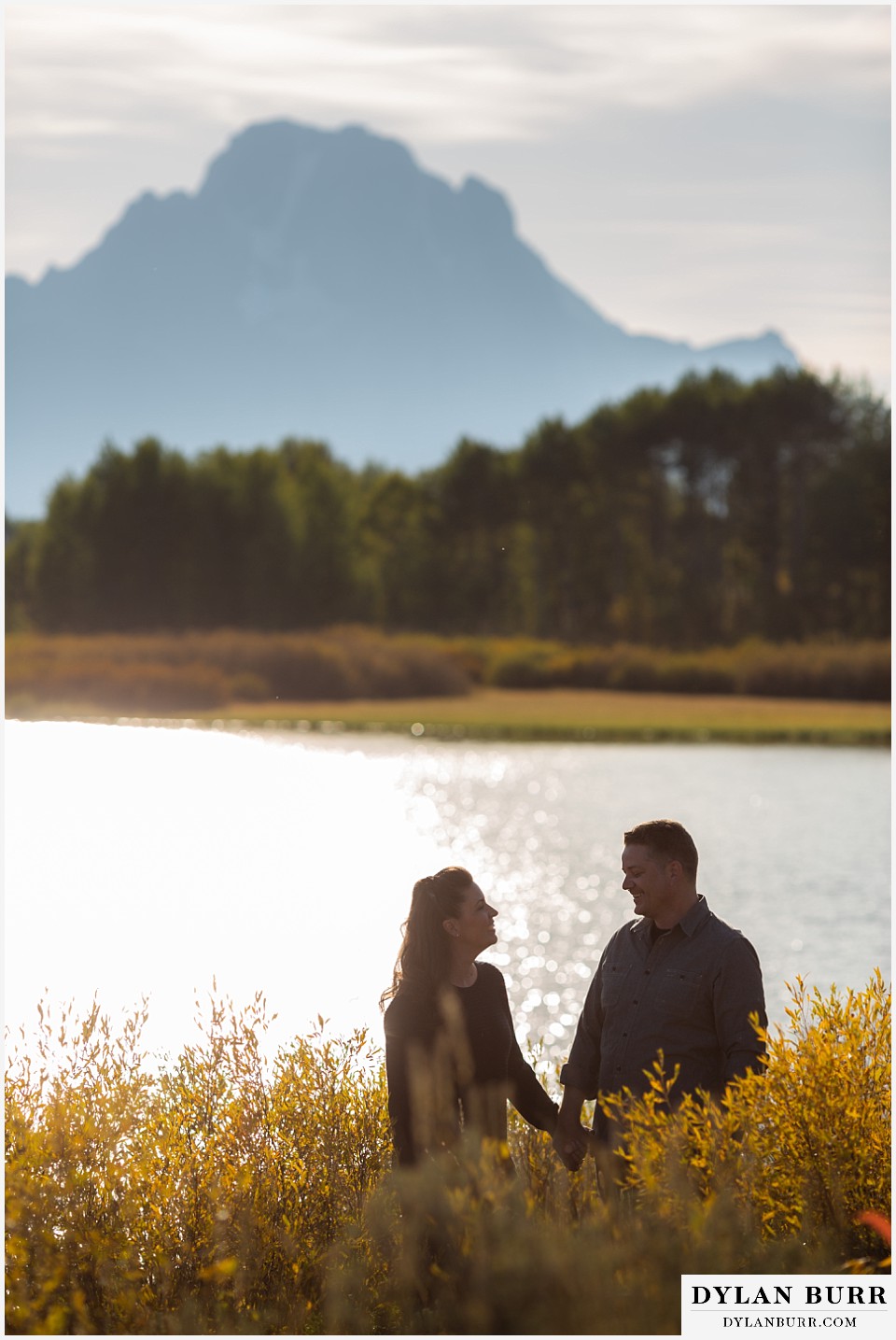 grand teton wedding anniversary photos married couple walking holding hands by snake river