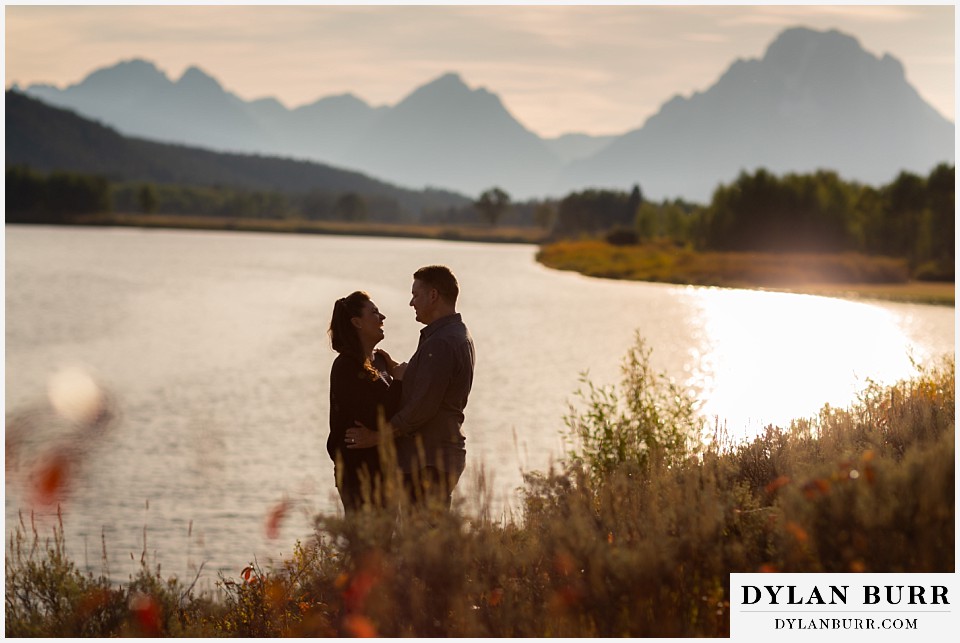 grand teton wedding anniversary photos couple standing together by snake river with mt moran in background