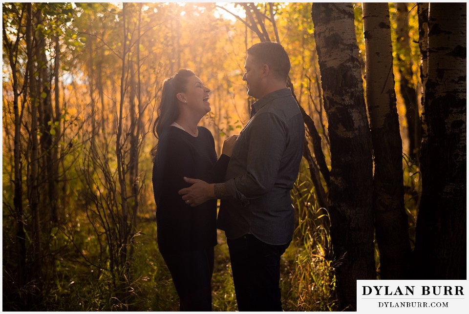 grand teton wedding anniversary photos couple laughing at sunset in trees