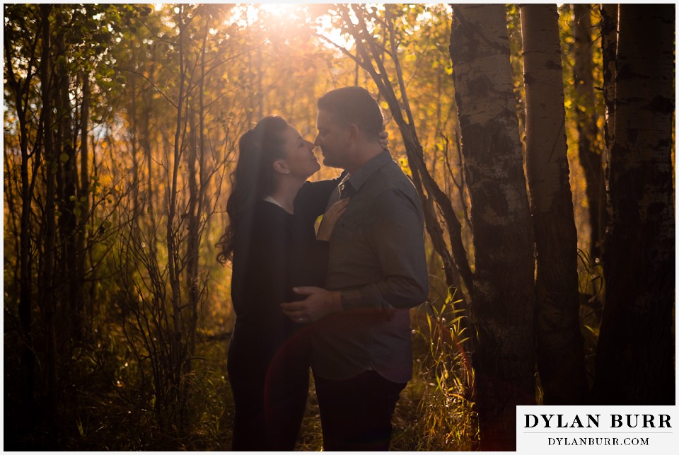 grand teton wedding anniversary photos couple together in trees at sunset 