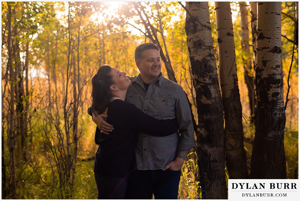 grand teton wedding anniversary photos couple relaxing together in trees during fall