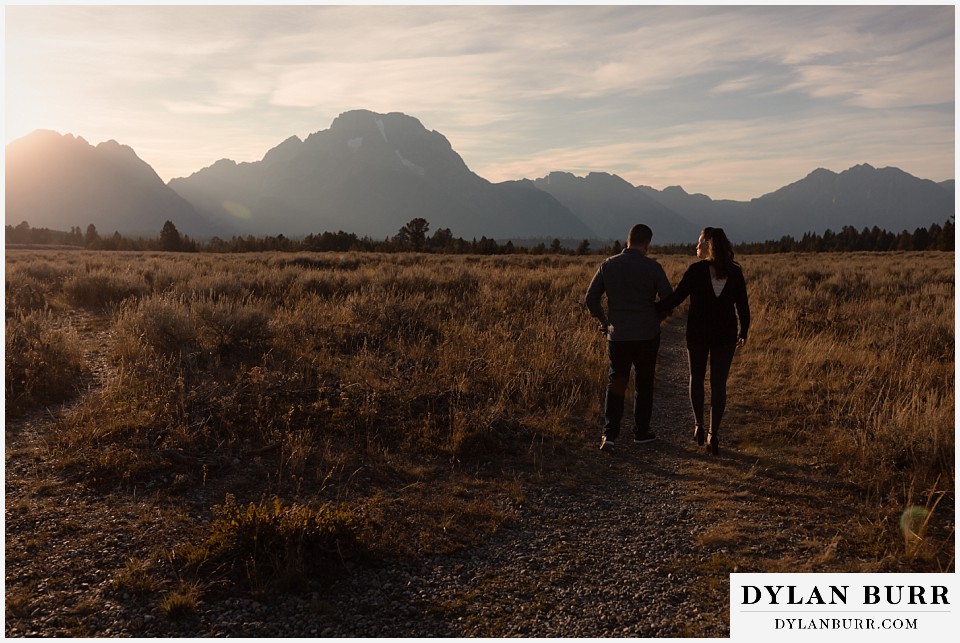 grand teton wedding anniversary photos couple walking along trail in national park