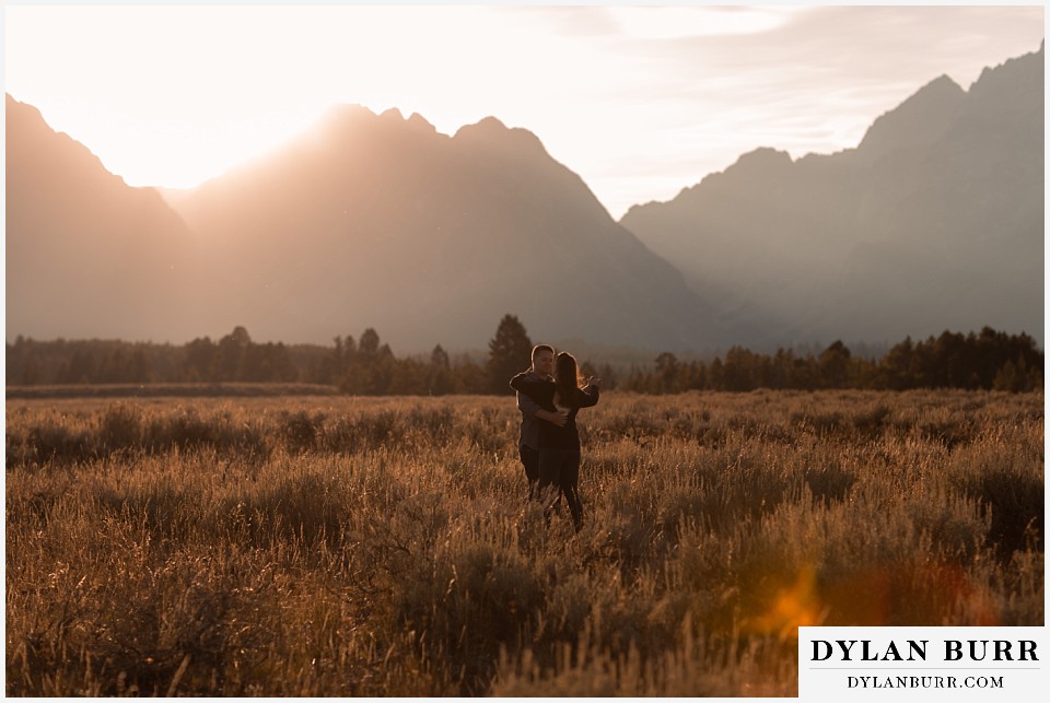 grand teton wedding anniversary photos couple dancing together with giant mountains behind them