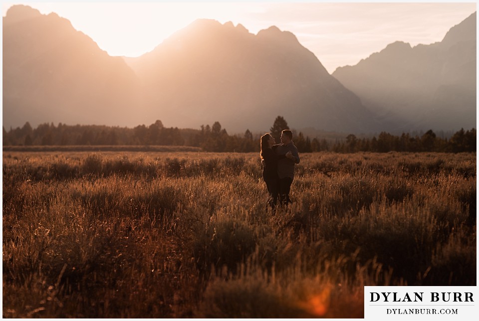 grand teton wedding anniversary photos dancing at sunset with mountains in the background