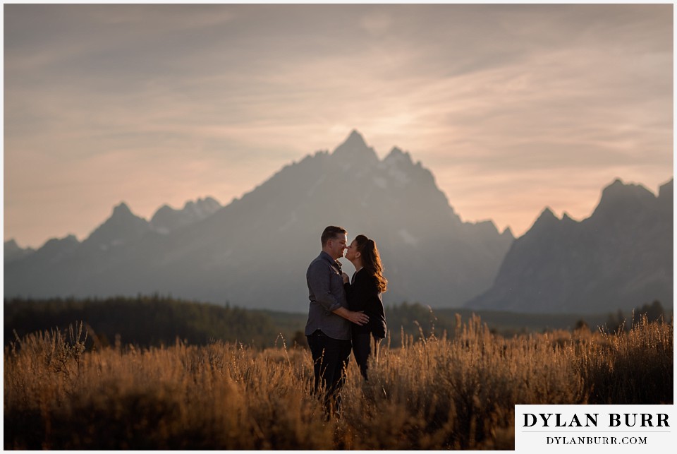 grand teton wedding anniversary photos couple kissing with grand teton peak behind them