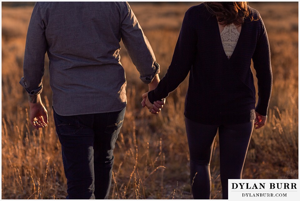 grand teton wedding anniversary photos couple holding hands in field