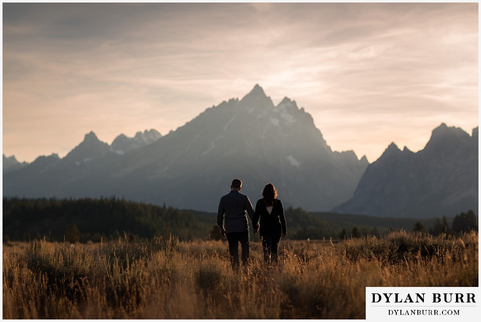 grand teton wedding anniversary photos couple walking away towards Grand Teton Peak