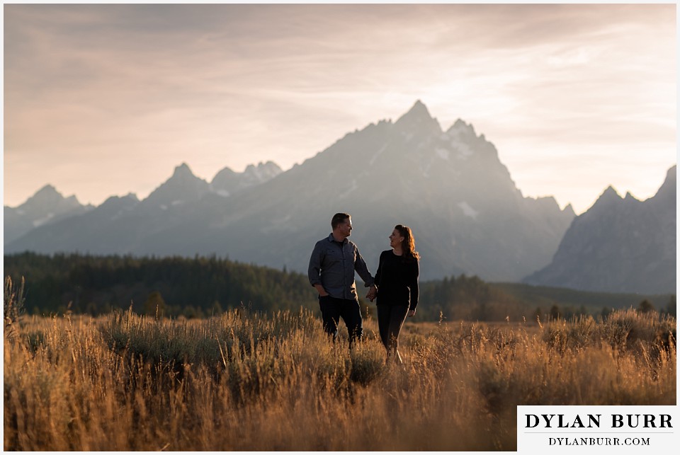 grand teton wedding anniversary photos turning around walking with mountains in the distance