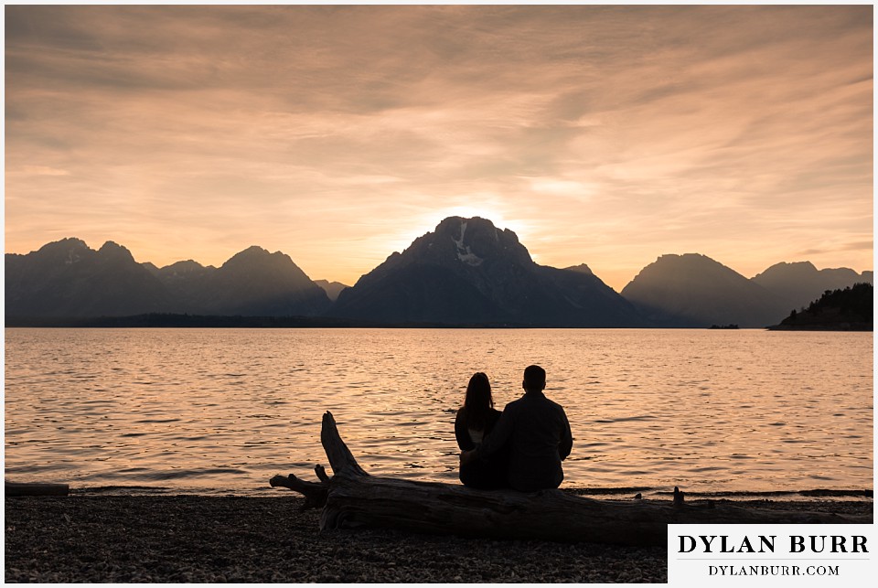 grand teton wedding anniversary photos couple looking out and enjoying the sunset at mt moran jackson lake