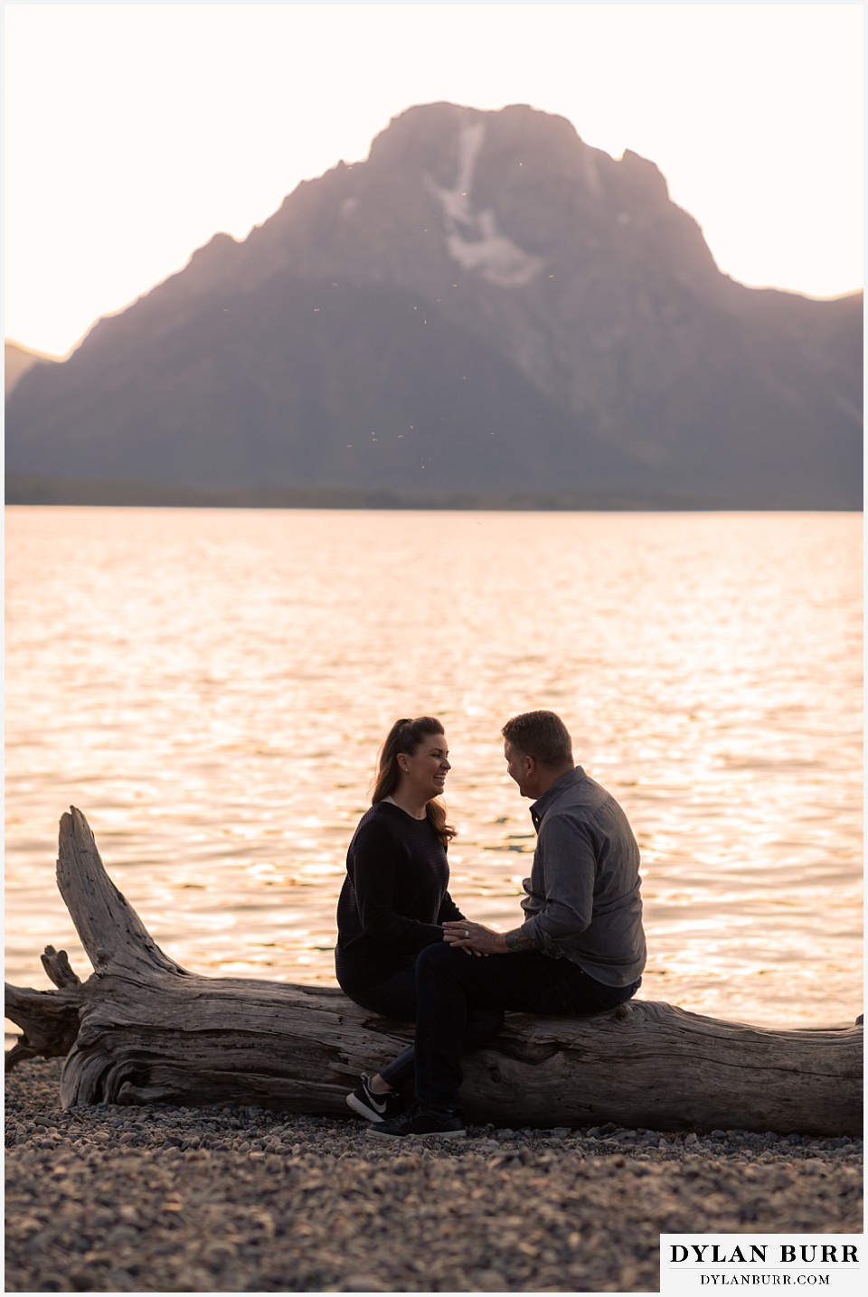 grand teton wedding anniversary photos couple playing games together while sitting on a log