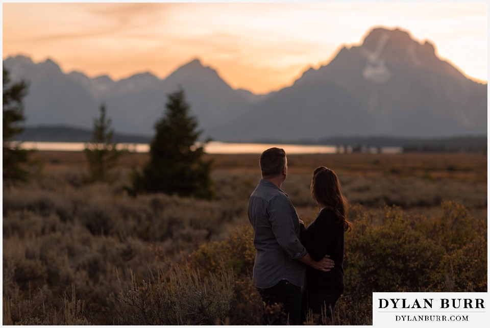 grand teton wedding anniversary photos couple turning to watch the sunset