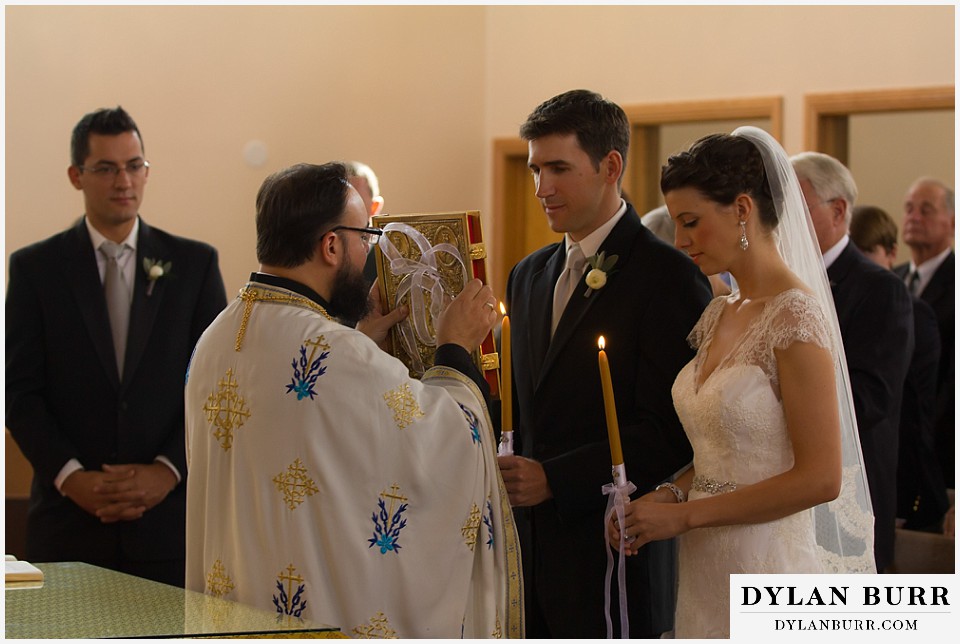 greek orthodox wedding bride and groom holding candles