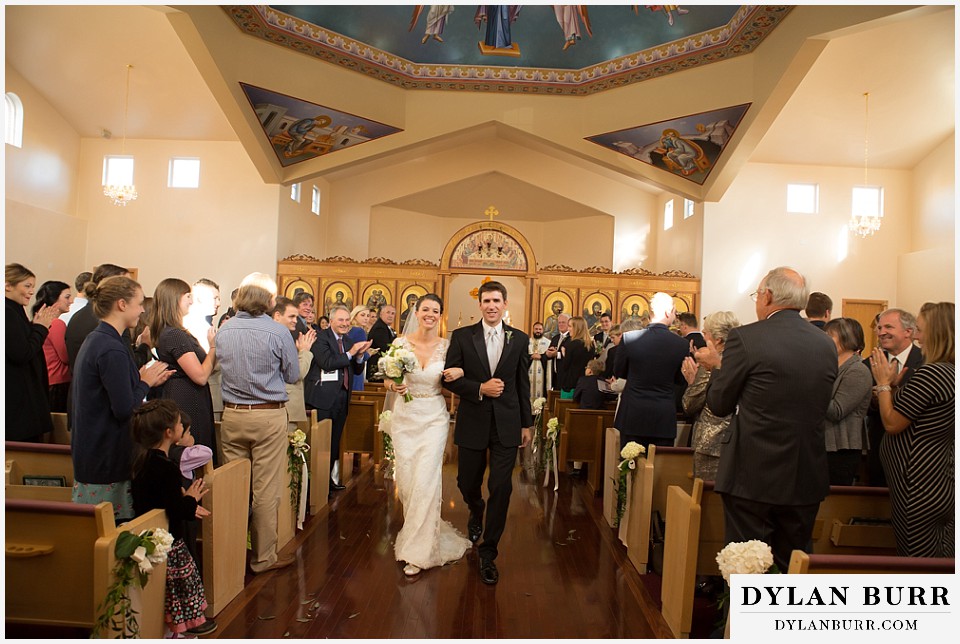 greek orthodox wedding bride and groom walking down aisle