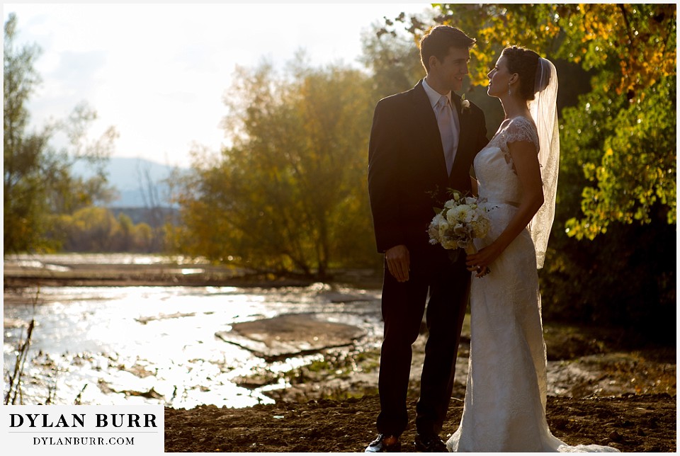 greek orthodox wedding bride and groom near a river at sunset
