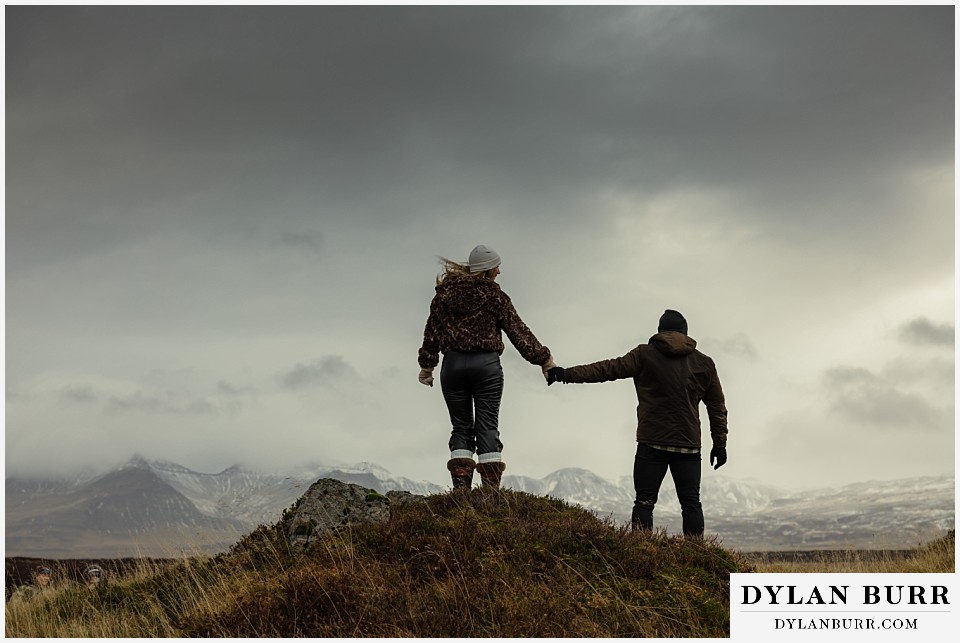 iceland hot springs engagement session together on a small rocky hill