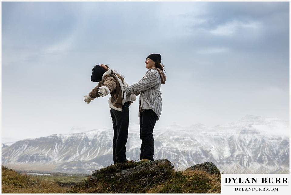 lgtbq couples hot springs session in Iceland couple being goofy on top of rocks