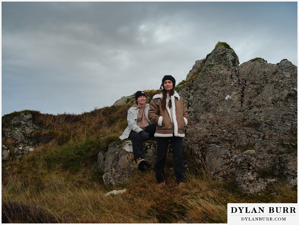 lgtbq couples hot springs session in Iceland together near some rocks and tall grasses