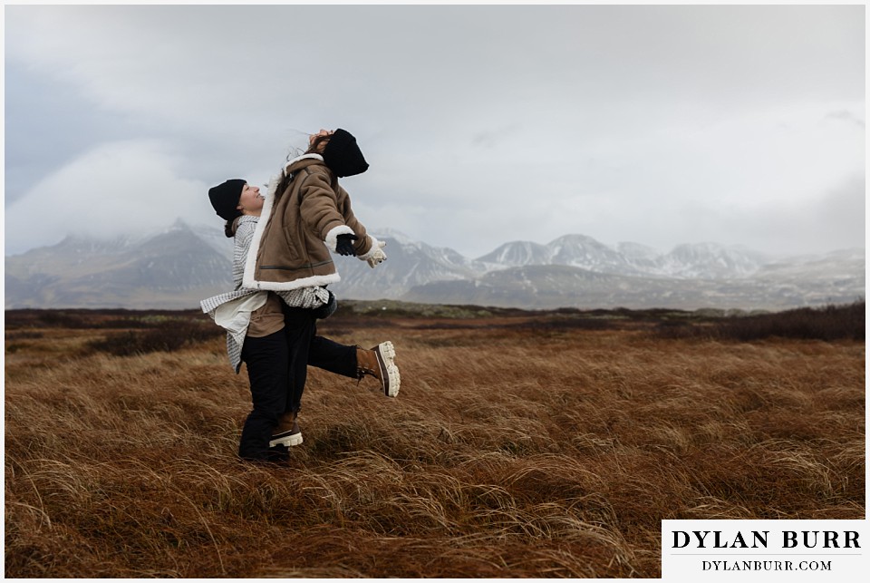 lgtbq couples hot springs session in Iceland being silly in a field