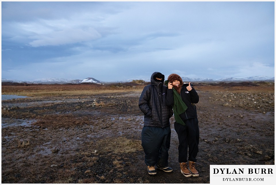 lgtbq couples hot springs session in iceland bundled up keeping warm after a soak