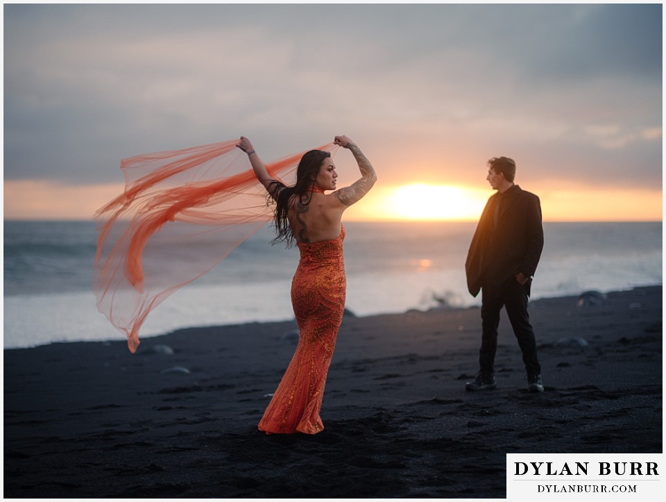 iceland elopement at reynisfjara beach orange dress bride and groom at sunset
