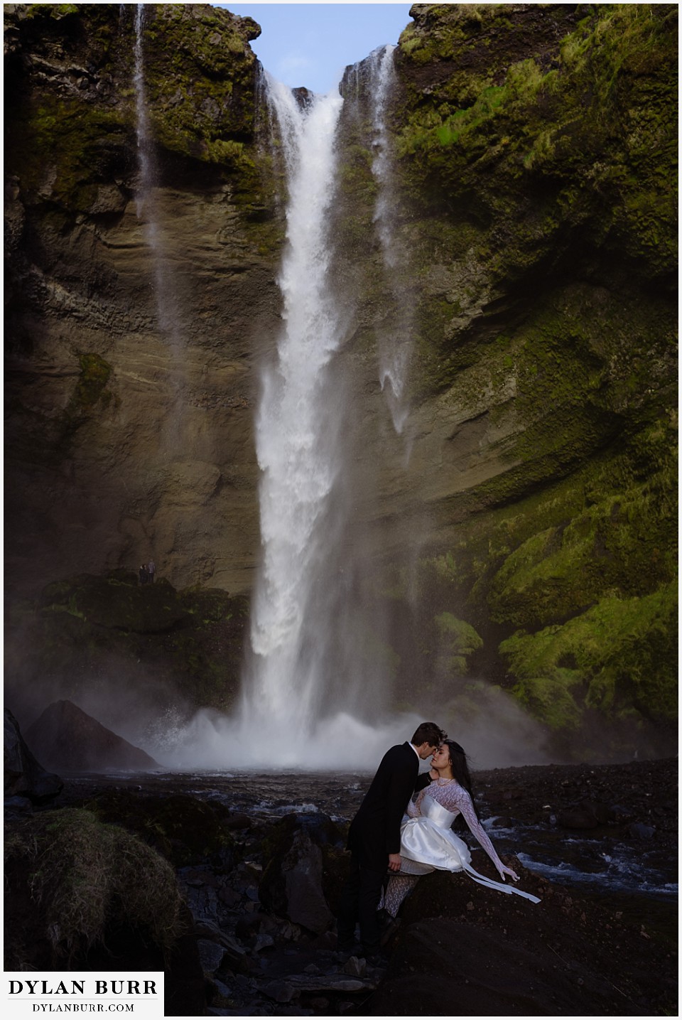 Iceland elopement wedding waterfall canyon near selfoss couple with tall waterfall kissing