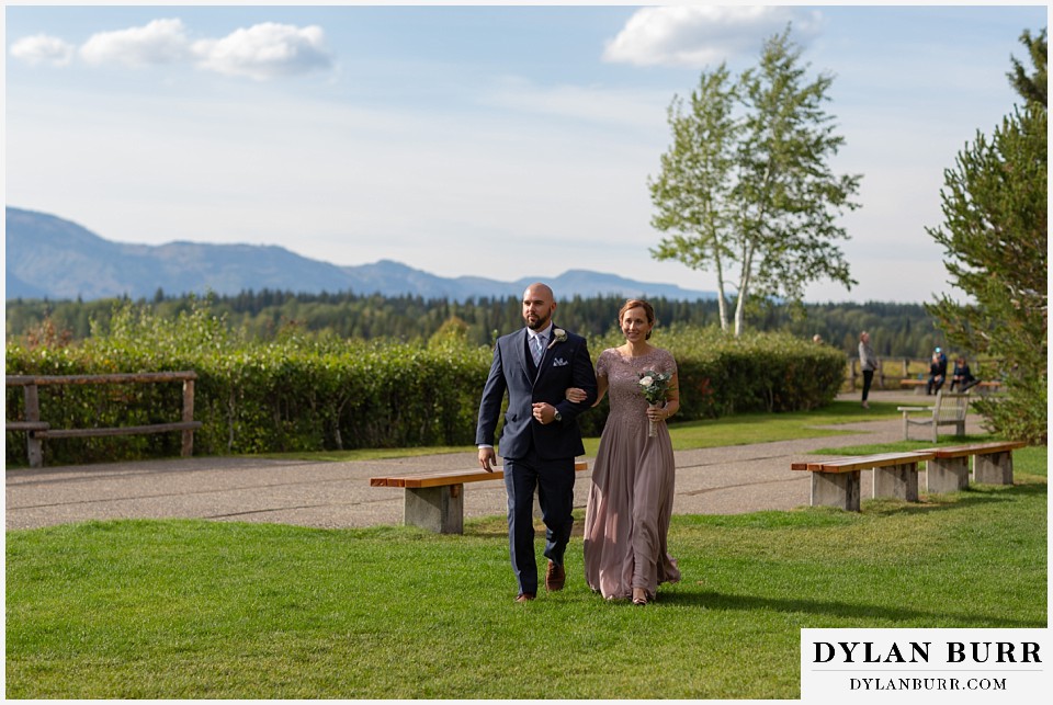 jackson lake lodge wedding grand tetons wyoming best man and maid of honor walking to ceremony site