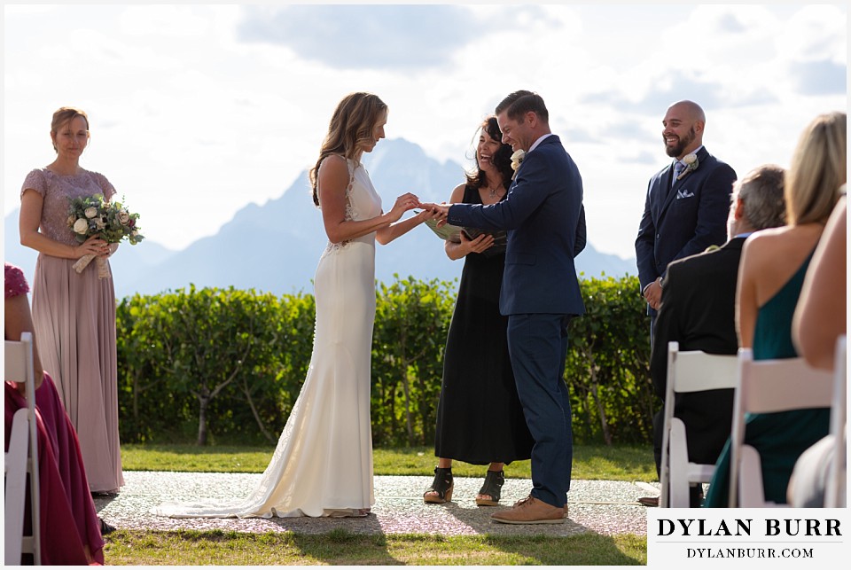 jackson lake lodge wedding grand tetons wyoming bride putting on groom's ring