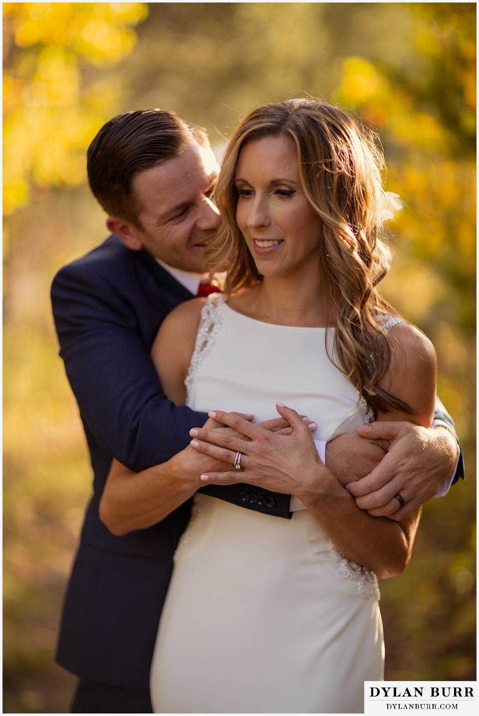 jackson lake lodge wedding grand tetons wyoming close up of bride and groom hugging in yellow aspen trees