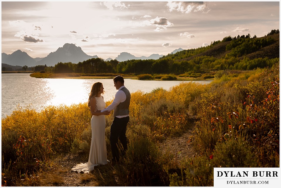 jackson lake lodge wedding grand tetons wyoming bride and near snake river at sunset 