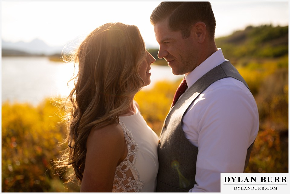 jackson lake lodge wedding grand tetons wyoming groom loving hard on his new wife at sunset