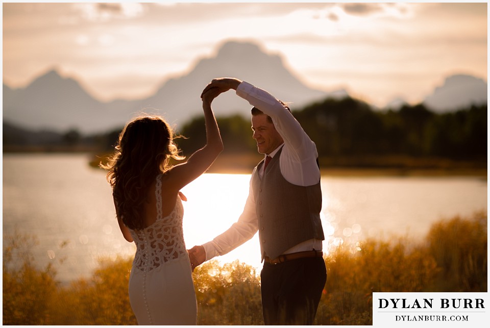 jackson lake lodge wedding grand tetons wyoming bride and groom dancing in tthe sunlight