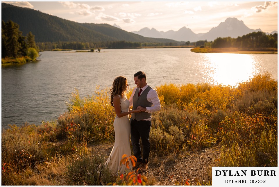 jackson lake lodge wedding grand tetons wyoming bride and groom laughing 