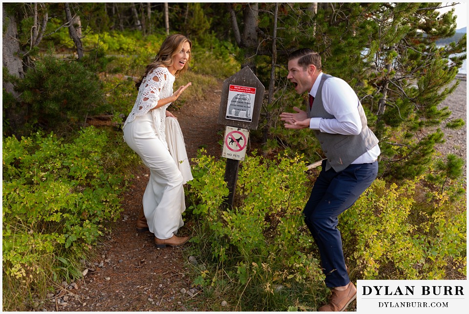 jackson lake lodge wedding grand tetons wyoming funny bride and groom bear aware sign