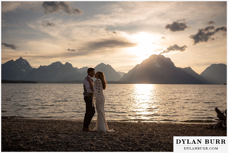 jackson lake lodge wedding grand tetons wyoming bride and groom kissing at jackson lake