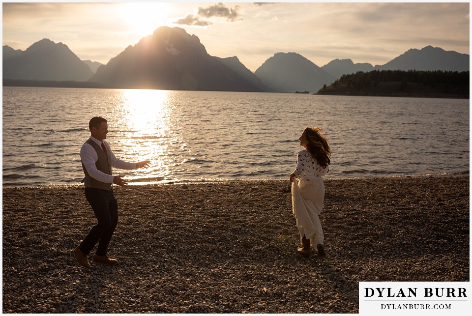 jackson lake lodge wedding grand tetons wyoming groom chasing bride by jackson lake