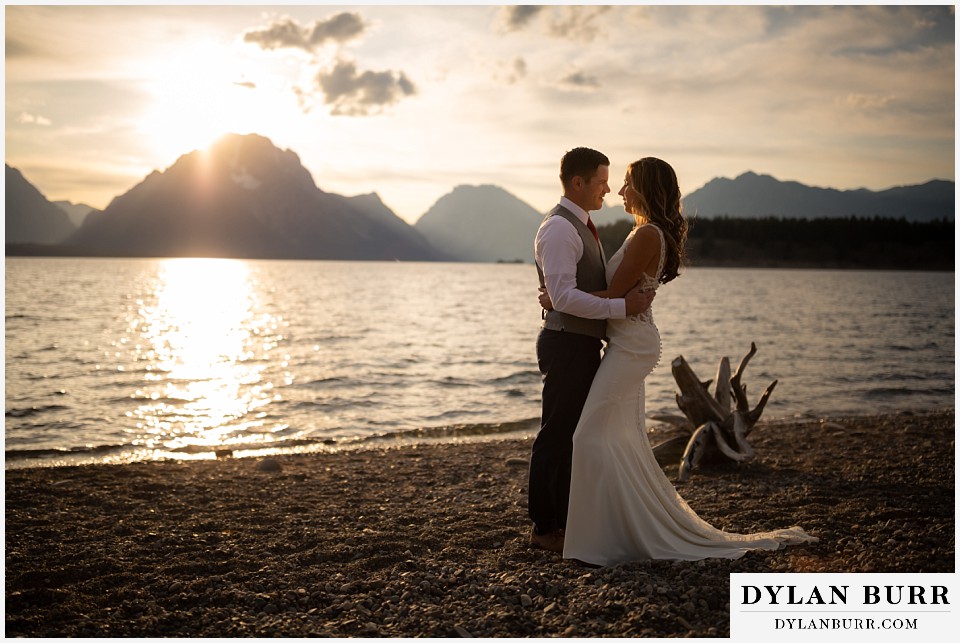 jackson lake lodge wedding grand tetons wyoming bride and groom in mountains by jackson lake