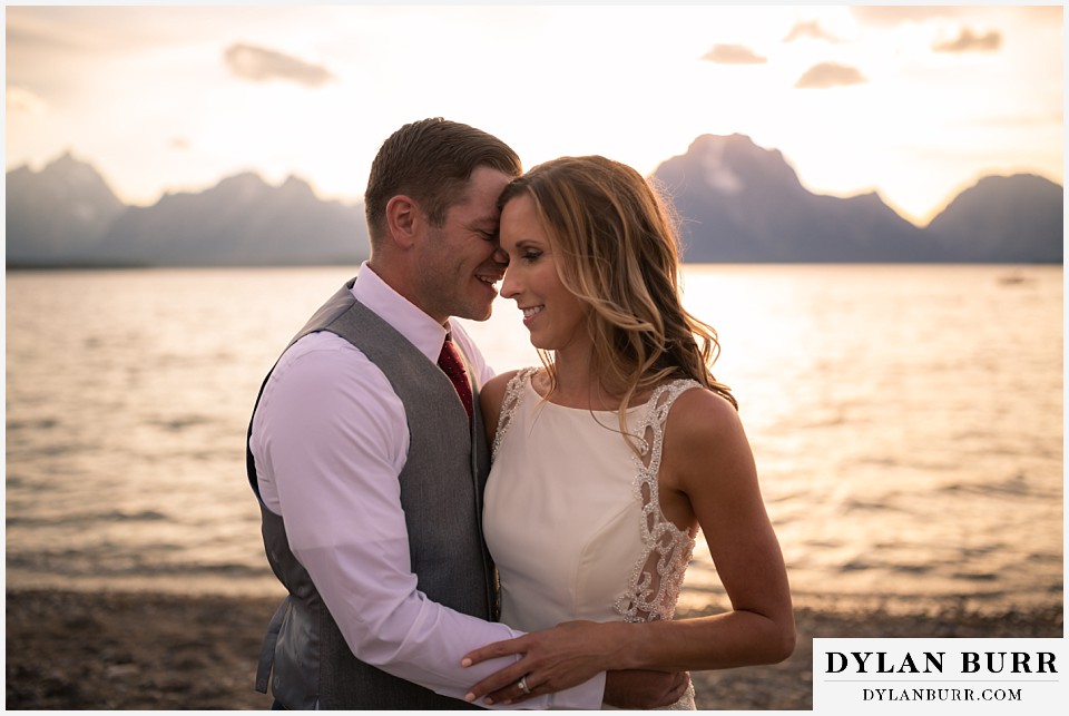 jackson lake lodge wedding grand tetons wyoming groom whispering into his wife's ear