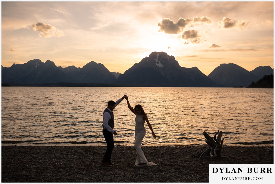 jackson lake lodge wedding grand tetons wyoming married couple at sunset dancing at jackson lake