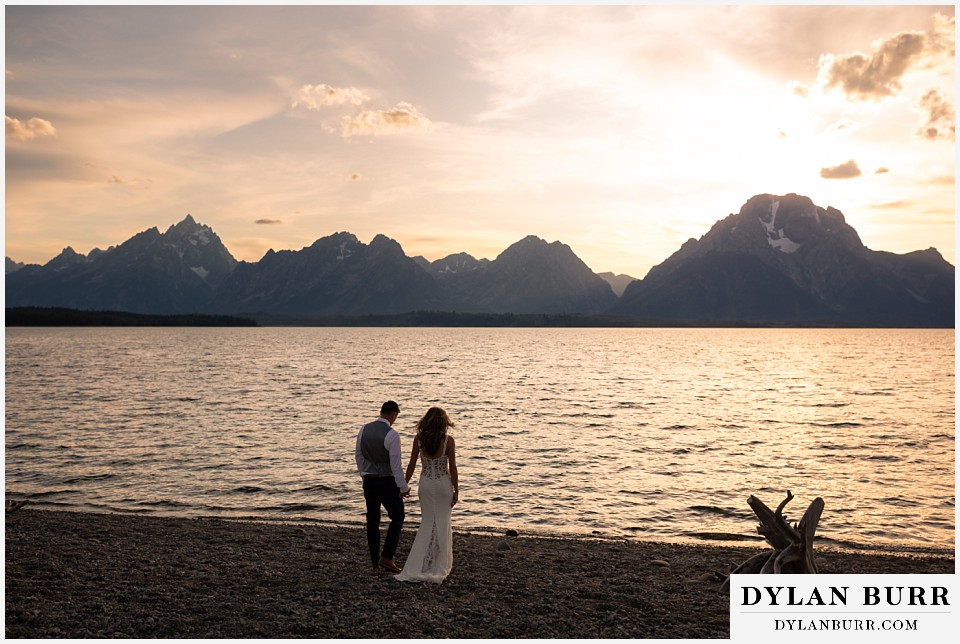 jackson lake lodge wedding grand tetons wyoming bride and groom walking to lake