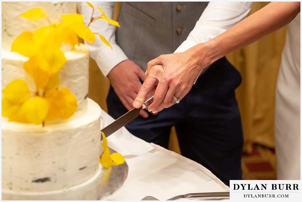 jackson lake lodge wedding grand tetons wyoming bride and groom cutting aspen wedding cake